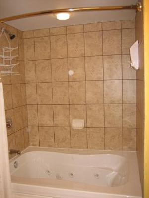 Relax in this comfortable jetted tub with a custom tile surround